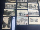 a lot of old photographs on display on a table