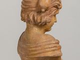 marble bust of a man with a hat on a table