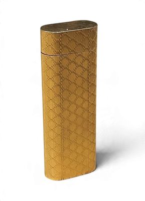 a gold lighter that is sitting on a white surface