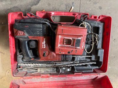 a red tool box with tools in it on the floor