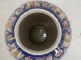 a blue and white vase sitting on a white table