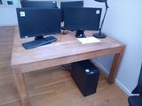 two computer monitors sitting on a desk with a keyboard and mouse