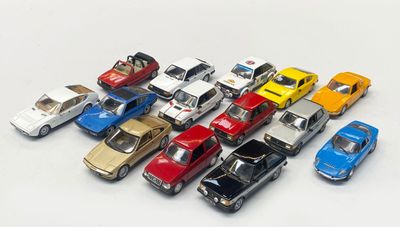 a lot of toy cars that are on a white surface
