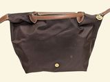 an image of a brown bag with a brown handle
