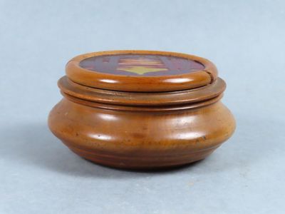 a small wooden box with a lid on a table