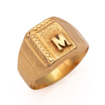 an image of a gold ring with a letter m on it