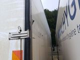 two semi trucks parked side by side in a parking lot