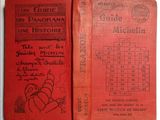 an old red book sitting on top of a table next to a calendar
