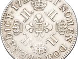 a close up of a silver coin with a crown on it
