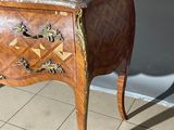 a small wooden table with a marble top on it