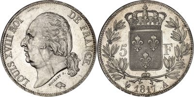 a silver coin with a crown on top of it