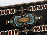 a black table with a gold and blue design on it