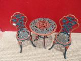 two chairs and a table with a flower design on it