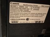 the back of a canon printer with a sticker on it ' s side
