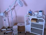 a picture of a room with a desk, chair, and a lamp