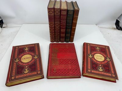 three books sitting on top of a white table next to each other