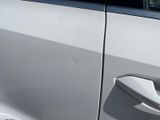 a close up of a door handle on a white car