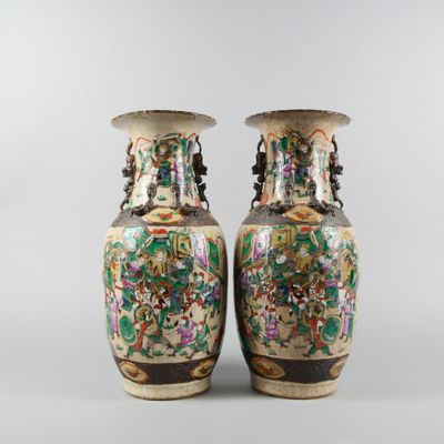 pair of chinese vases with floral designs on them on a gray background