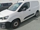 a white van parked in a parking lot next to a black van