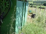 a green toilet sitting in the middle of a field