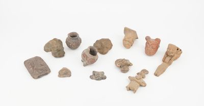 several pieces of pottery are displayed on a white surface