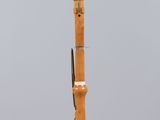 an image of a wooden instrument on display on a clear surface