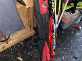a pile of skis and ski poles in a storage area