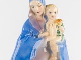 a figurine of a woman holding a baby in her lap