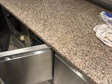 a sink in the middle of a counter in a kitchen