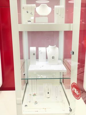 a glass display case with jewelry inside of it