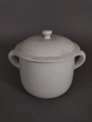 a white pot with a lid sitting on a table