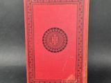 a red book with a black and white design on it