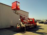 a red crane that is parked in front of a building