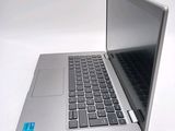 a silver laptop computer sitting on top of a white table