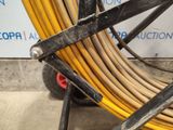 a yellow hose that is attached to a cart