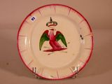 a red and white plate with a bird painted on it