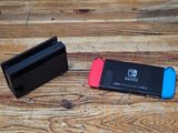 two nintendo wii controllers sitting next to each other on a wooden table