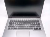 an open laptop computer sitting on top of a white table