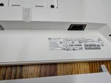 a close up of a white laptop on a wooden table