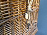 a wicker basket that has a handle on it