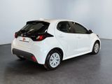 the rear end of a white car parked in a room