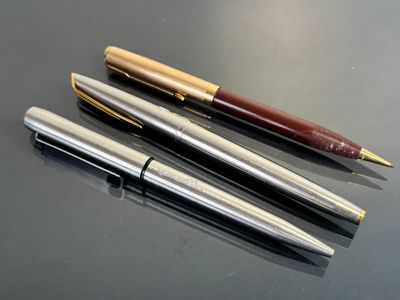 three different types of pens are lined up on a table