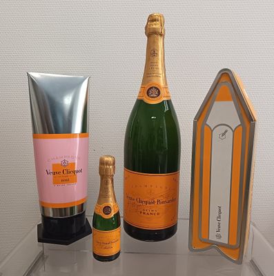three bottles of champagne and a bottle of hand cream on a table