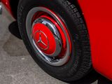 a close up of a red car with a black rim