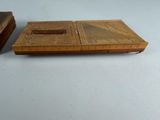 a small wooden box that has a ruler on top of it