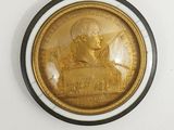 a gold coin with a picture of a man on it
