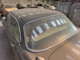 an old car that is parked in a garage