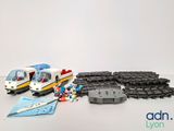 a toy train that is sitting next to some legos