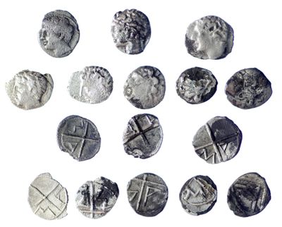 some silver coins are arranged in a circle on a white surface