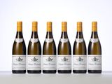 six bottles of white wine lined up in a row